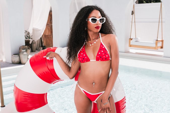 Mia Love in red white blue bikini posing with American flag photo 2