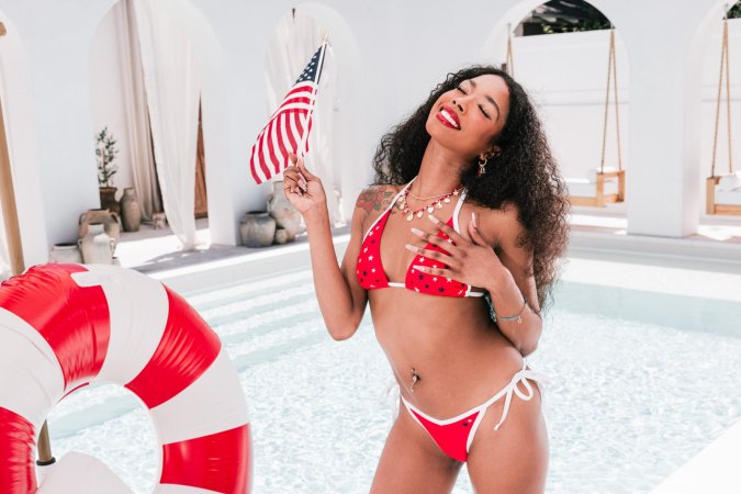 Mia Love in red white blue bikini posing with American flag photo 5