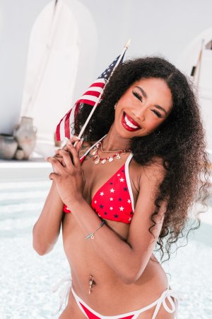 Mia Love in red white blue bikini posing with American flag photo 6