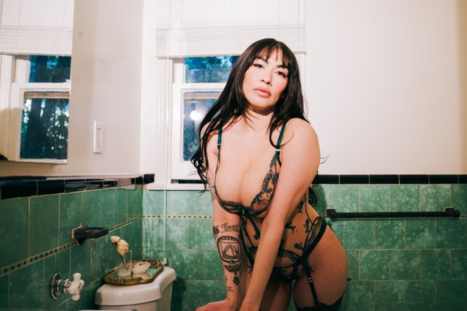 Sabina Magic in emerald lace lingerie on tiled bathroom floor photo 1