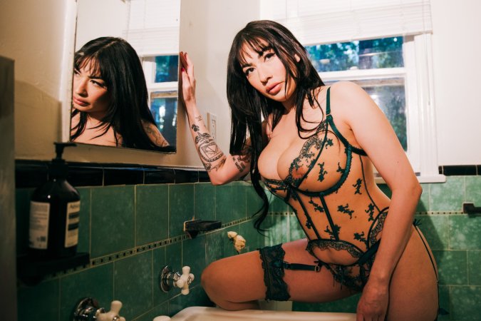 Sabina Magic in emerald lace lingerie on tiled bathroom floor photo 2