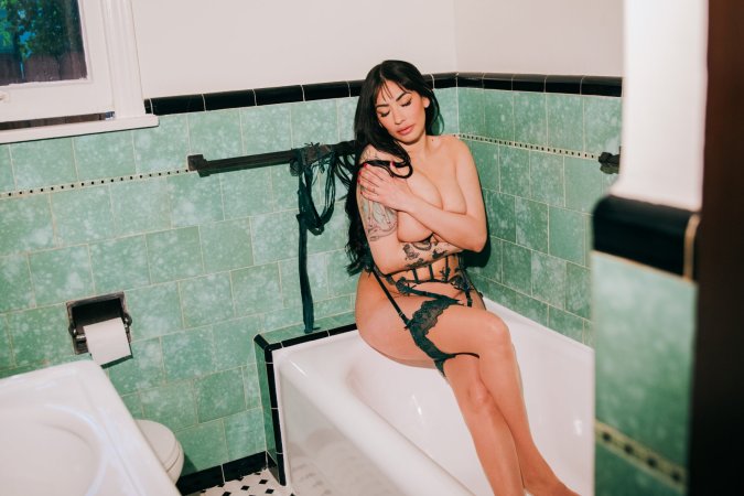 Sabina Magic in emerald lace lingerie on tiled bathroom floor photo 9