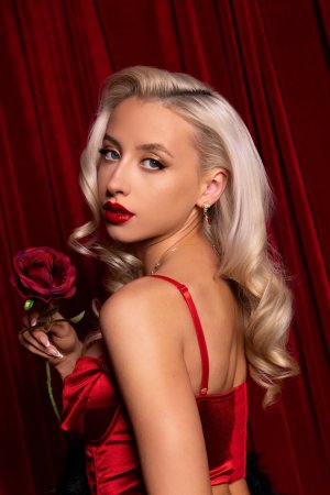 Ally Lanes poses nude with rose against velvet curtains photo 2