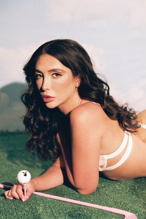 Jane Wilde posings with pink golf club on green grass photo 7