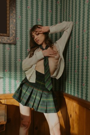 Ivy Rose in schoolgirl skirt poses topless in bedroom with mirror and lamp photo 6