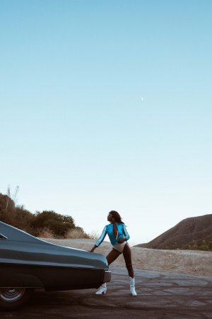 Victoria Antoinette poses in bodysuit and jacket by classic car photo 1