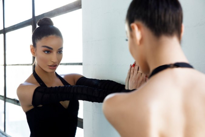 Emily Willis bodysuit knee socks kneeling stretching dance studio light photo 5