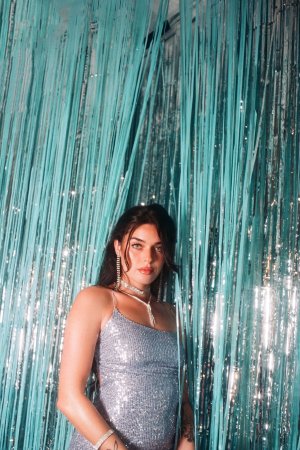 Megan Star in silver sparkle against teal fringe white boots photo 2