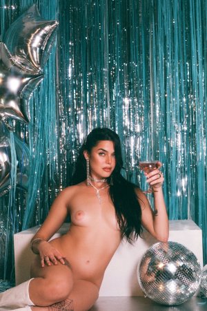 Megan Star in silver sparkle against teal fringe white boots photo 12
